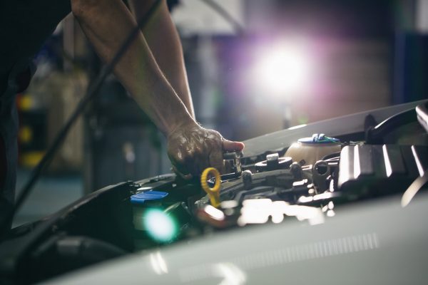 A mechanic performing maintenance on a car engine